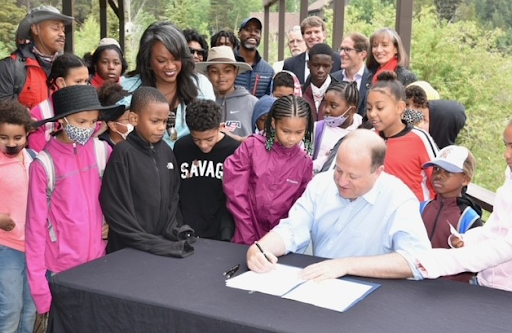 Governor Polis signs HB 21-1318 at the Lincoln Hills Flyfishing Club in Black Hawk